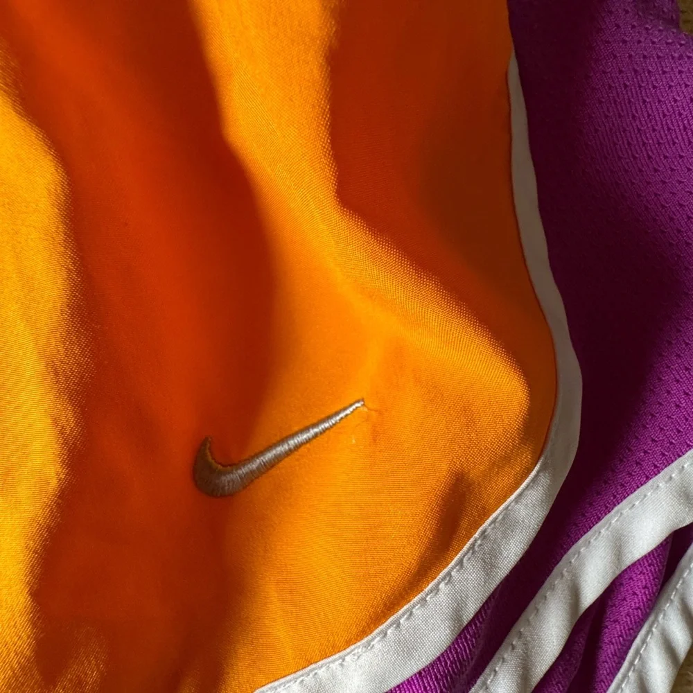 Nike Women's Orange Running Shorts with Purple Side Panels